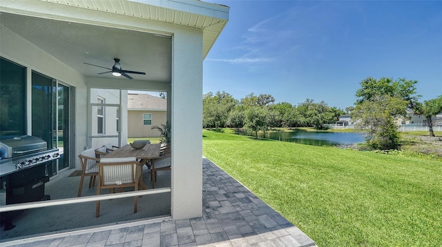 exterior space featuring ceiling fan, a water view, and a patio