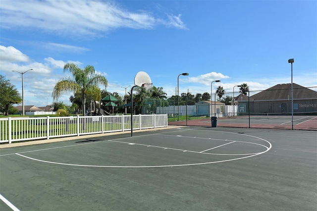 view of basketball court featuring tennis court