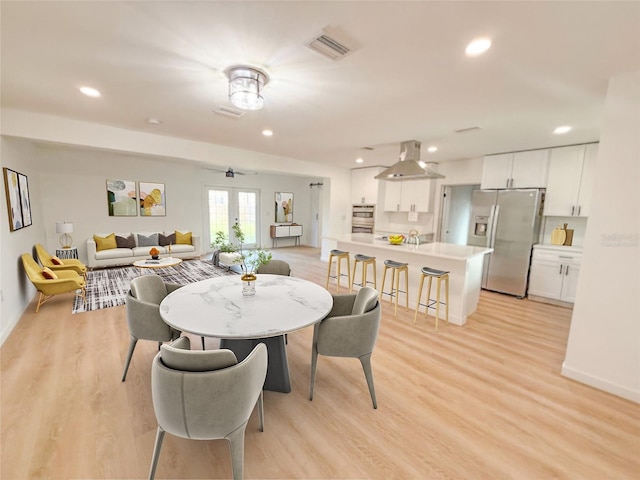 dining area featuring light hardwood / wood-style floors and french doors