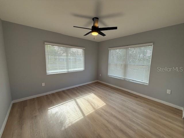 empty room featuring ceiling fan and light hardwood / wood-style flooring