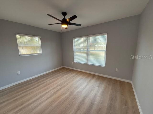 unfurnished room featuring ceiling fan, a healthy amount of sunlight, and light wood-type flooring