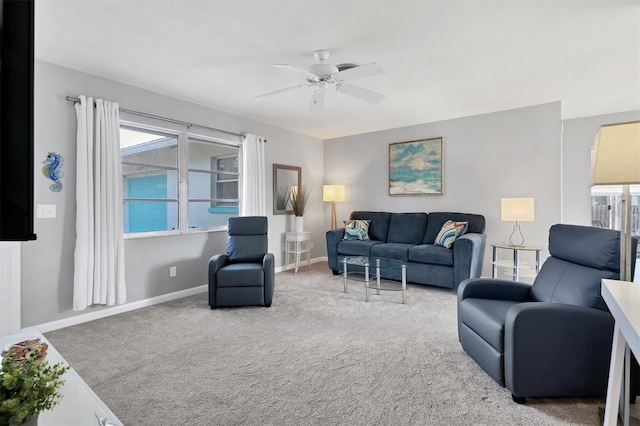 carpeted living room with ceiling fan