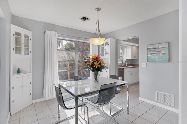 dining room featuring light tile patterned flooring and sink