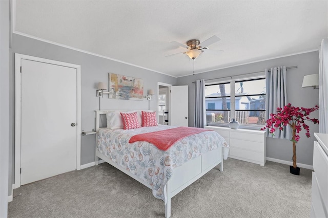 carpeted bedroom with ceiling fan and crown molding