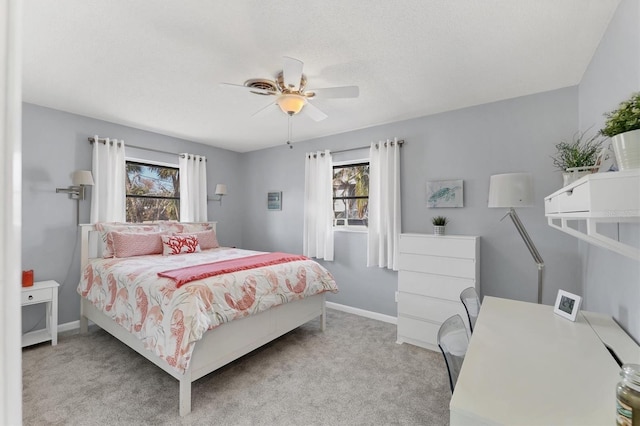 bedroom with ceiling fan and light colored carpet