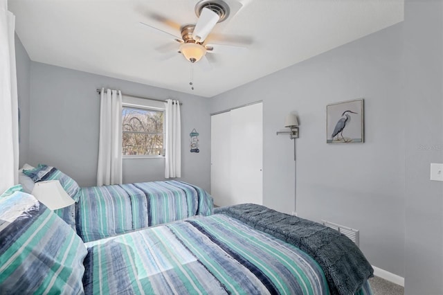 carpeted bedroom with a closet and ceiling fan