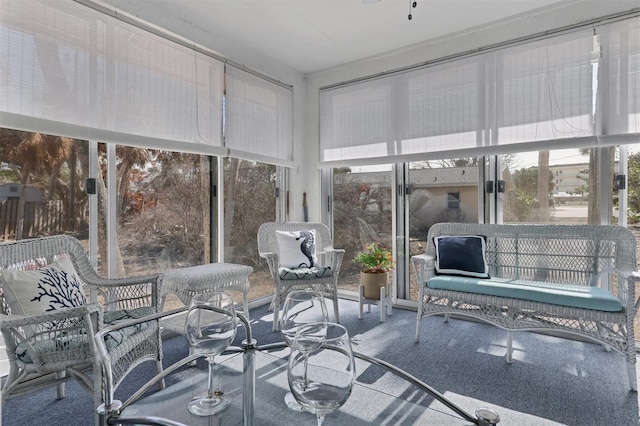 sunroom / solarium featuring ceiling fan