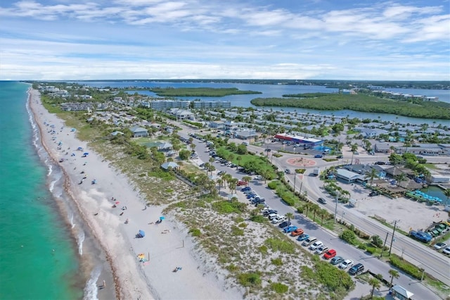 drone / aerial view featuring a beach view and a water view