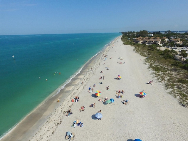 bird's eye view featuring a view of the beach and a water view