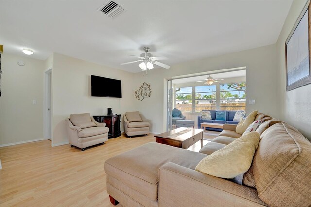 living room with hardwood / wood-style floors and ceiling fan