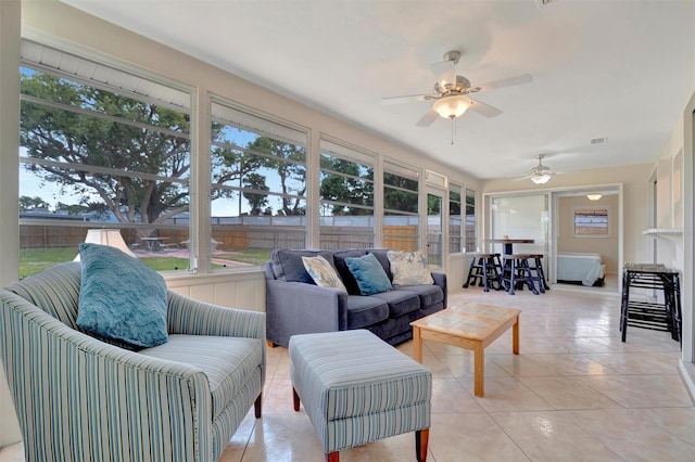 sunroom featuring ceiling fan