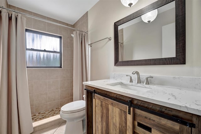 bathroom featuring tile patterned flooring, vanity, toilet, and walk in shower