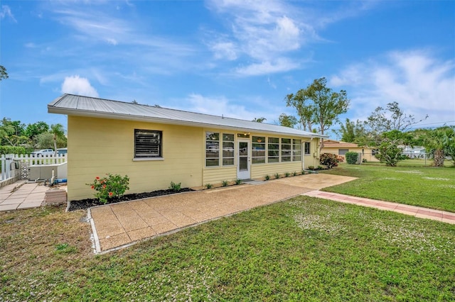 back of property featuring a lawn