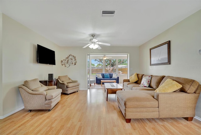 living room with light wood-type flooring and ceiling fan