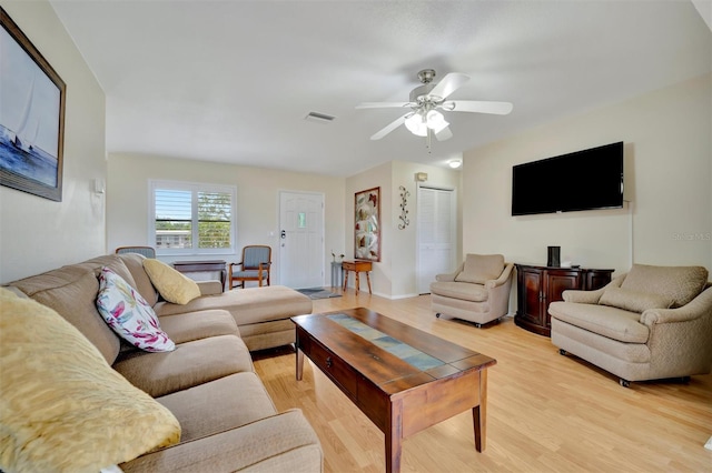 living room featuring ceiling fan and light hardwood / wood-style floors