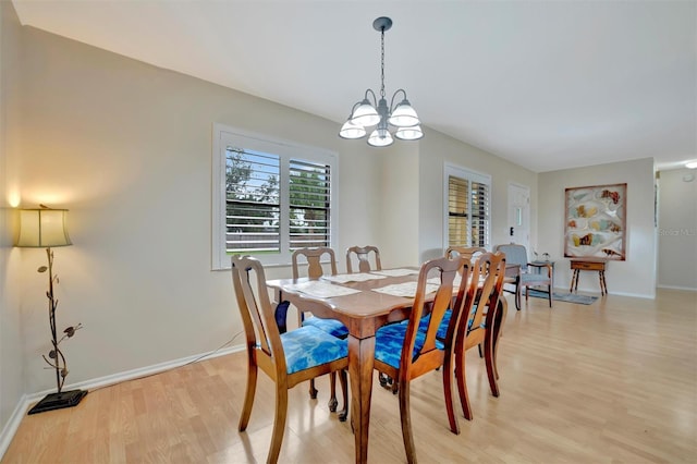 dining room with a chandelier and light wood-type flooring