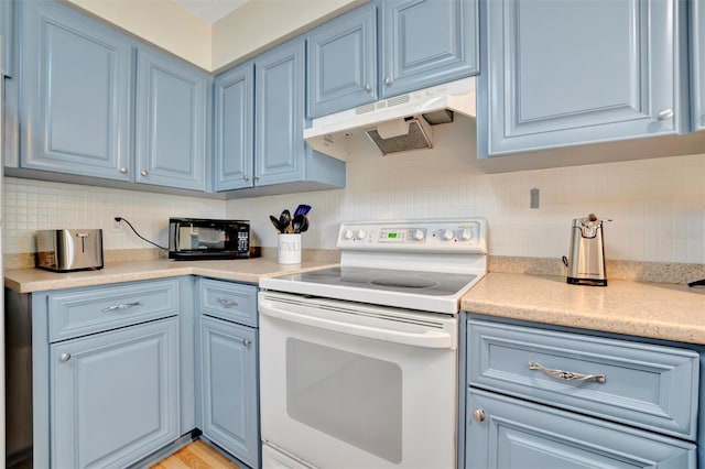 kitchen with tasteful backsplash, white range with electric cooktop, and blue cabinets