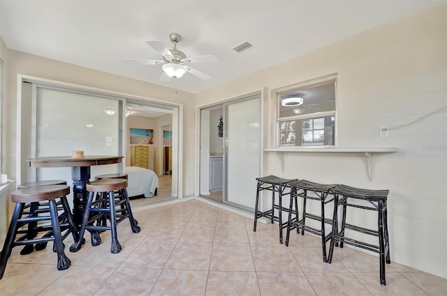 dining space featuring ceiling fan and light tile patterned floors