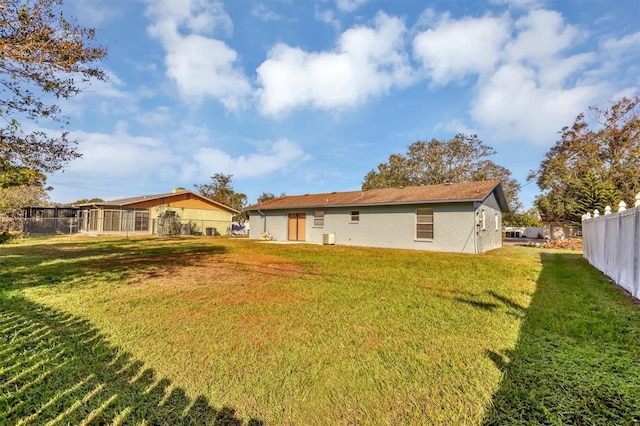 rear view of house with a yard