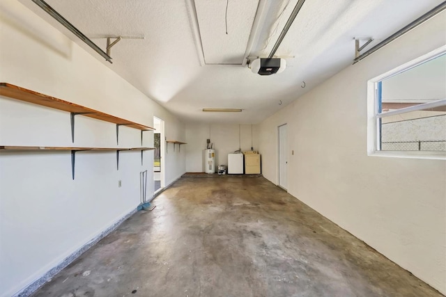 garage featuring washer and clothes dryer, electric water heater, and a garage door opener