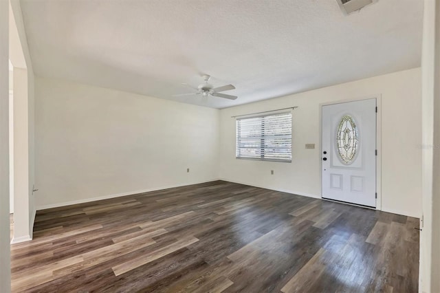 entryway featuring a textured ceiling, ceiling fan, and dark hardwood / wood-style floors