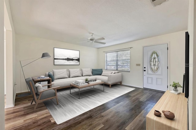 living room featuring a textured ceiling, dark hardwood / wood-style flooring, and ceiling fan