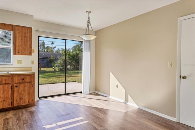 unfurnished dining area with light wood-type flooring