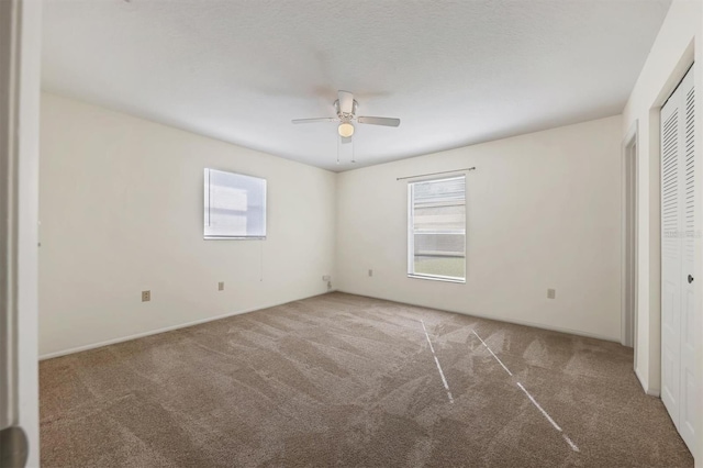 unfurnished bedroom with ceiling fan and carpet