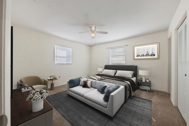 bedroom featuring ceiling fan, a closet, and dark carpet