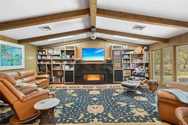 living room featuring a high end fireplace, vaulted ceiling with beams, and wood walls