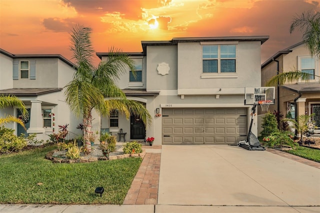 view of front of house featuring a yard and a garage