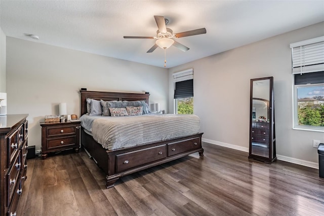 bedroom with ceiling fan and dark hardwood / wood-style floors