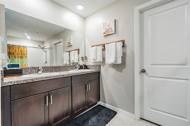 bathroom with tile patterned flooring, a shower with curtain, and vanity