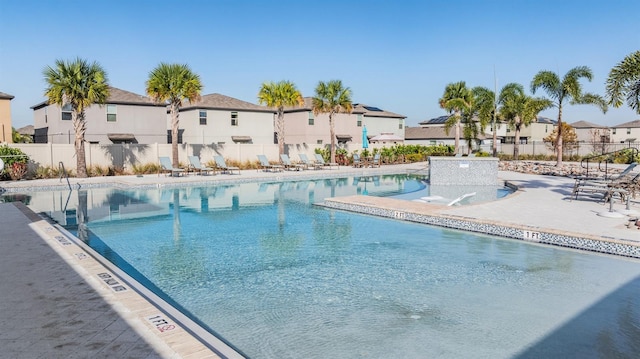 view of swimming pool featuring pool water feature and a patio