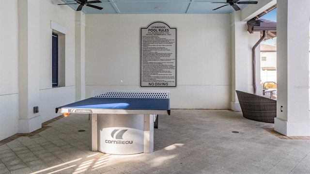 interior space with ceiling fan