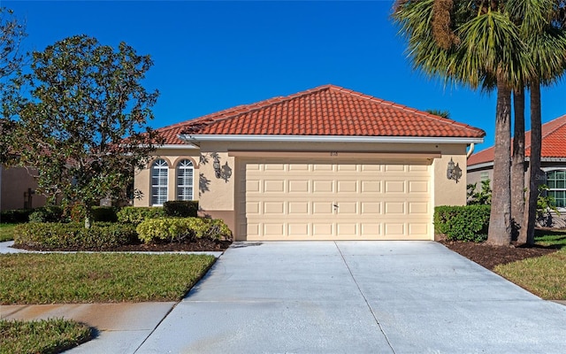 mediterranean / spanish house with a garage