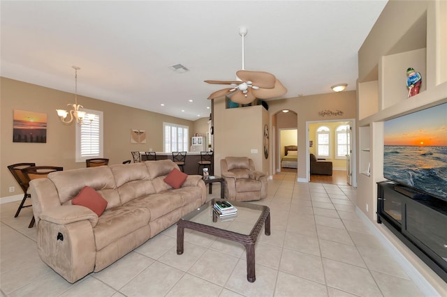 living room with light tile patterned floors and ceiling fan with notable chandelier