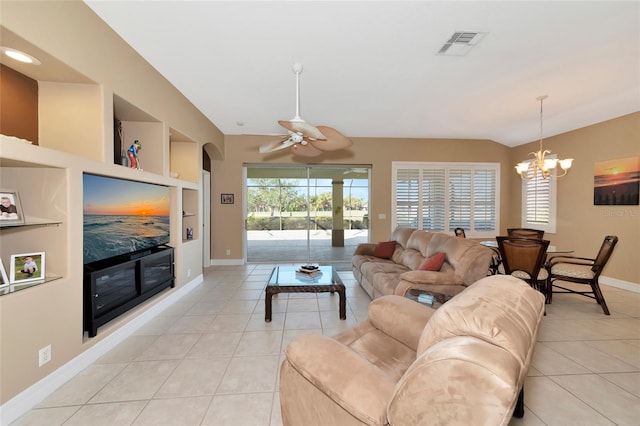 tiled living room featuring built in shelves and ceiling fan with notable chandelier