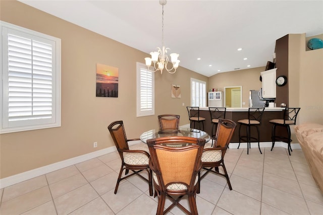 tiled dining room with a notable chandelier