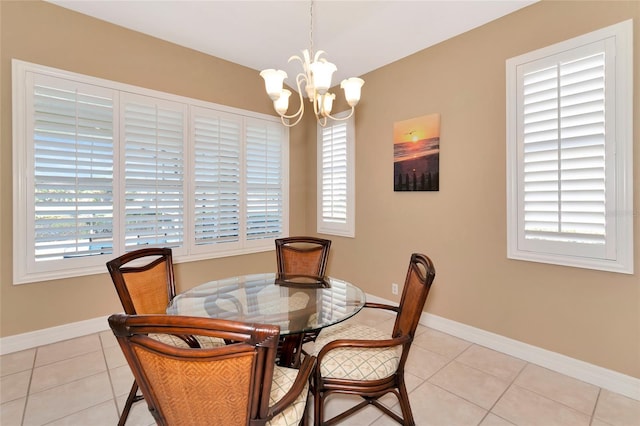 tiled dining area featuring a chandelier