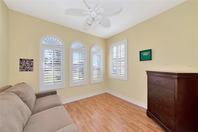 living area with light hardwood / wood-style flooring and ceiling fan