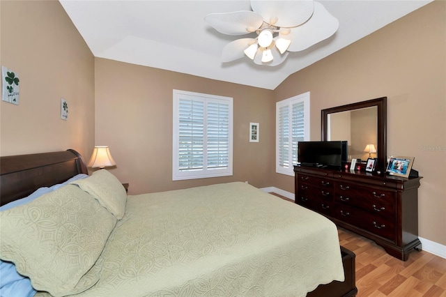 bedroom featuring light hardwood / wood-style floors, ceiling fan, and lofted ceiling