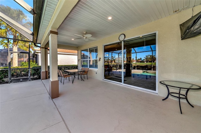 view of patio / terrace featuring glass enclosure and ceiling fan