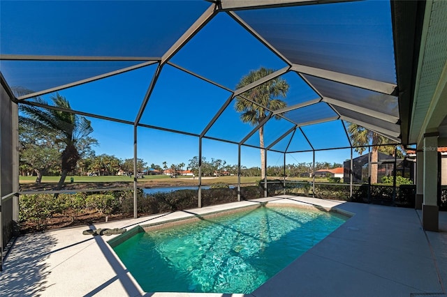 view of swimming pool featuring a lanai, a patio area, and a water view