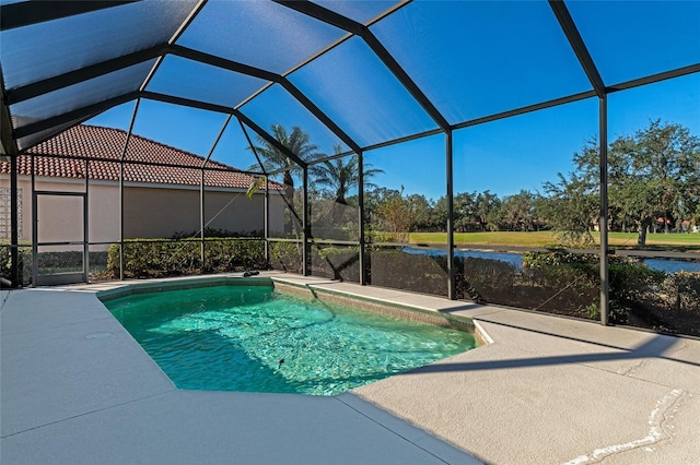 view of pool with glass enclosure and a water view