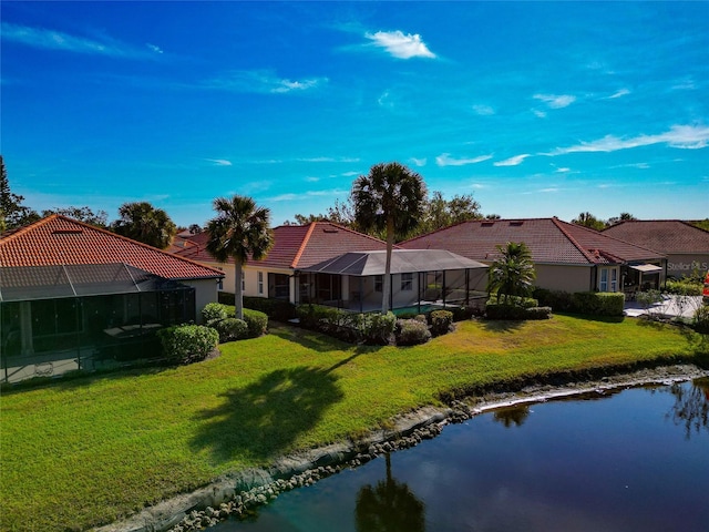 616 Misty Pond Ct, Bradenton, FL 34212 - back of house with a lawn, a tile roof, and a lanai
