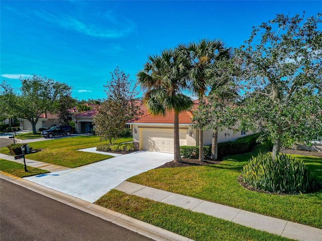 616 Misty Pond Ct, Bradenton, FL 34212 - view of front facade featuring a front yard, stucco siding, concrete driveway, a tiled roof, and a garage