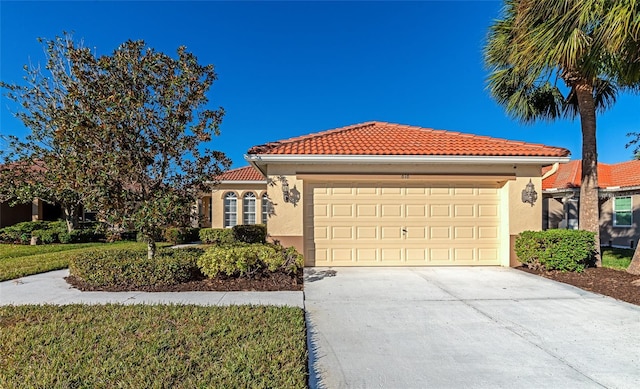 616 Misty Pond Ct, Bradenton, FL 34212 - mediterranean / spanish-style house featuring a tiled roof, a garage, stucco siding, and concrete driveway