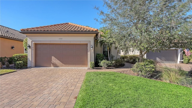 mediterranean / spanish house featuring a front yard and a garage