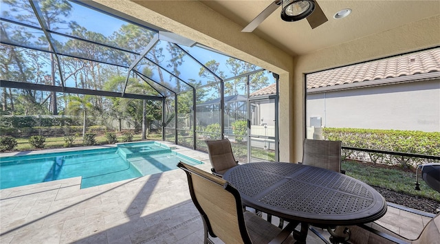 view of pool with ceiling fan, a lanai, and a patio